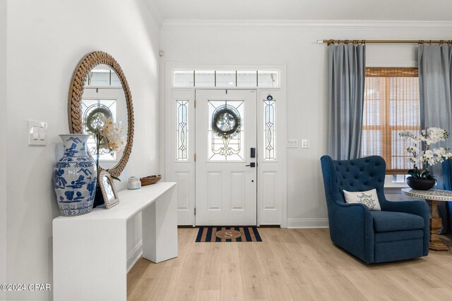 foyer entrance featuring ornamental molding and light hardwood / wood-style flooring