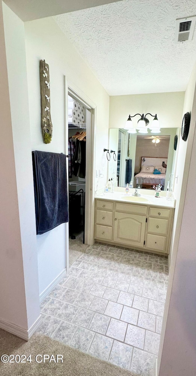 bathroom featuring vanity and a textured ceiling