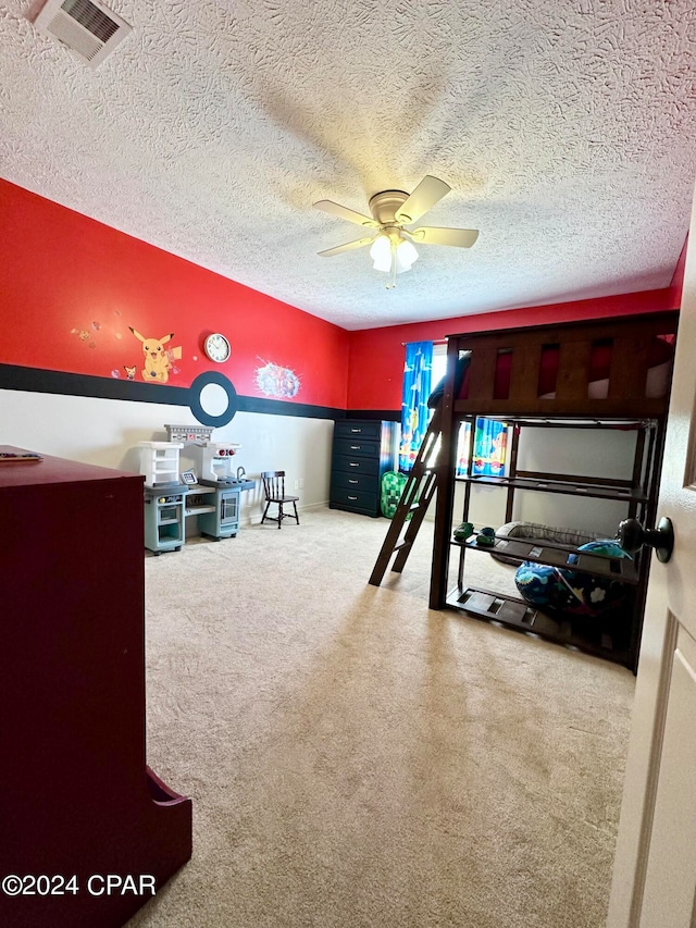 unfurnished bedroom featuring a textured ceiling, ceiling fan, and carpet flooring