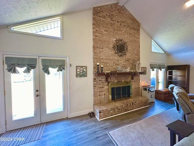 living room with hardwood / wood-style flooring, a healthy amount of sunlight, and a textured ceiling