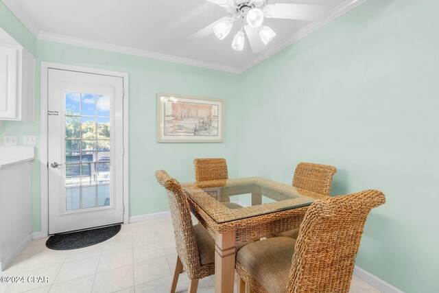 dining area featuring ceiling fan, light tile patterned floors, and crown molding