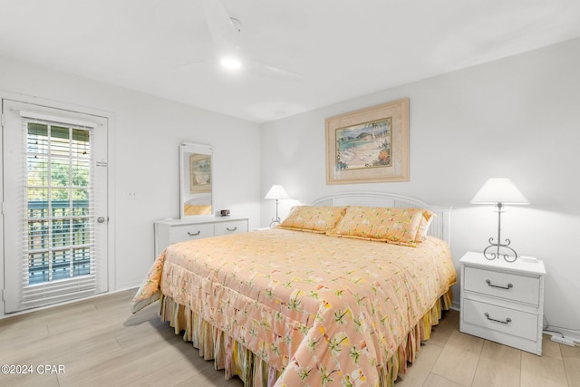 bedroom with access to exterior and light wood-type flooring