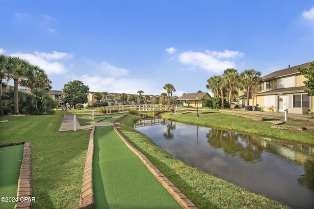 view of home's community with a yard and a water view