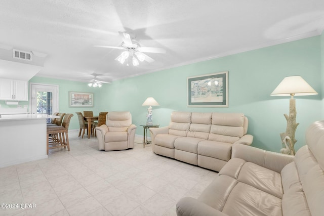 living room featuring ceiling fan and crown molding