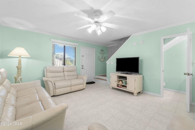 living room with ceiling fan, ornamental molding, and a textured ceiling