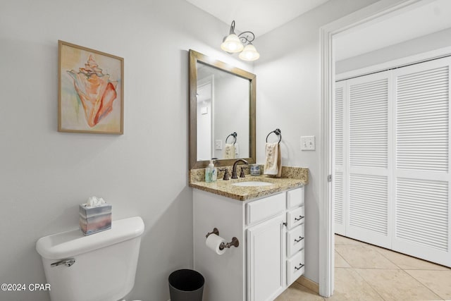 bathroom featuring vanity, toilet, and tile patterned floors