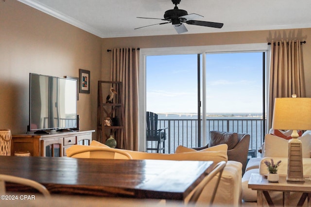 dining space featuring ornamental molding, a water view, and ceiling fan