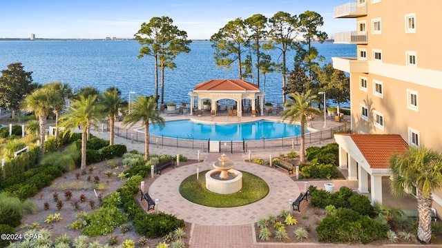 view of swimming pool featuring a patio area, a gazebo, and a water view