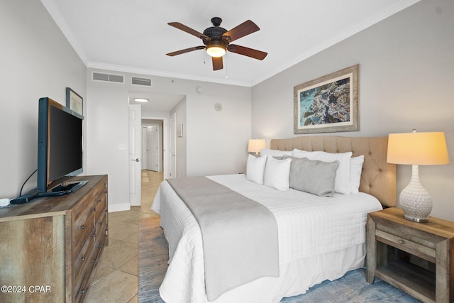 tiled bedroom featuring ornamental molding and ceiling fan