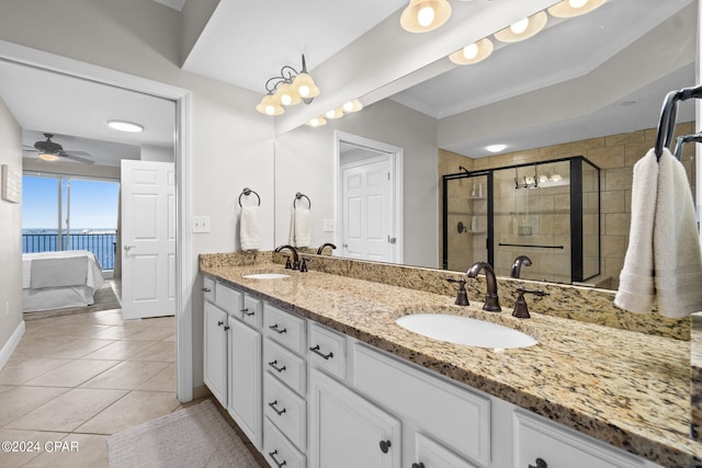 bathroom featuring ceiling fan, walk in shower, vanity, a water view, and tile patterned flooring