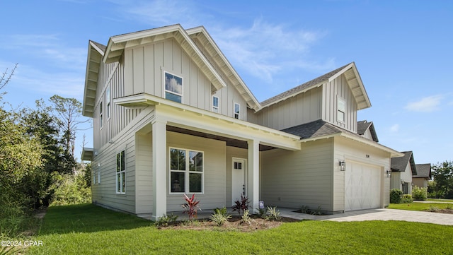 front facade with a garage and a front lawn