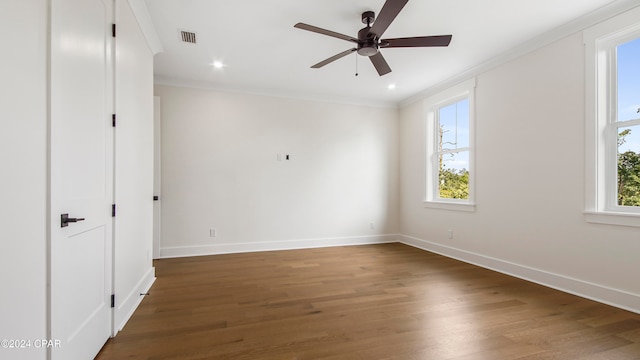 spare room with dark hardwood / wood-style floors, ornamental molding, and ceiling fan