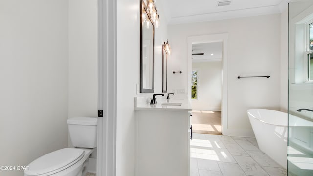 bathroom featuring a bathtub, vanity, tile patterned flooring, and toilet