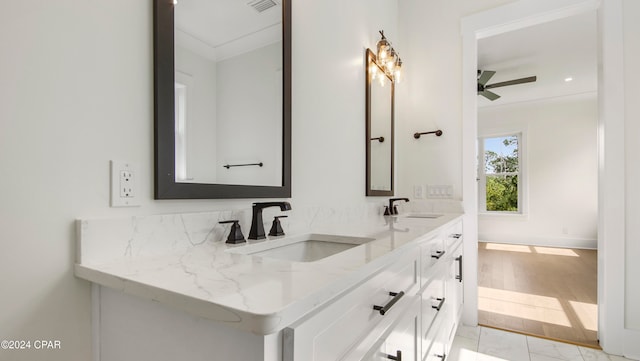 bathroom featuring ceiling fan, vanity, ornamental molding, and hardwood / wood-style flooring