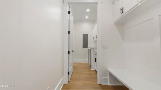 mudroom featuring electric panel and light hardwood / wood-style floors