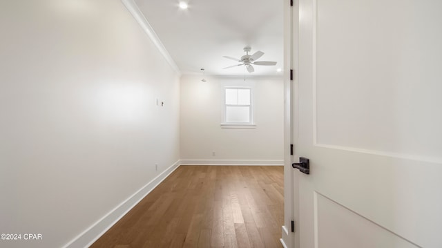 spare room featuring ornamental molding, hardwood / wood-style flooring, and ceiling fan