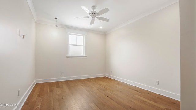 empty room with light hardwood / wood-style floors, ornamental molding, and ceiling fan