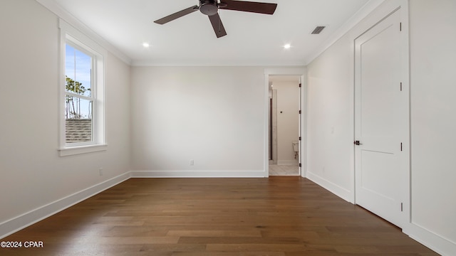 unfurnished bedroom with ceiling fan, ornamental molding, and dark hardwood / wood-style flooring