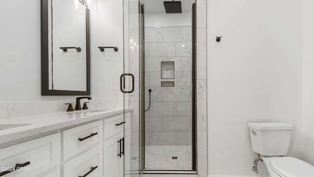 bathroom with an enclosed shower, vanity, and toilet