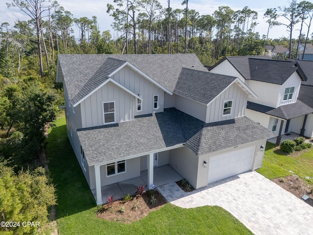 view of front of home with a front yard and a garage