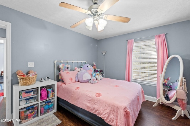 bedroom with dark hardwood / wood-style flooring and ceiling fan