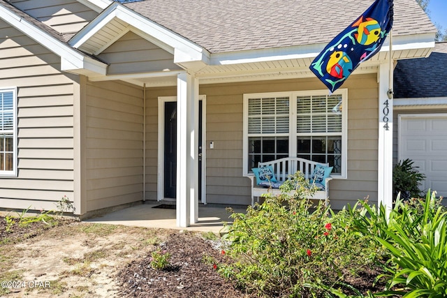 property entrance featuring a garage and covered porch