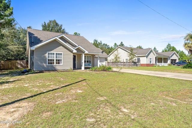 view of front of house with a garage, a porch, and a front yard