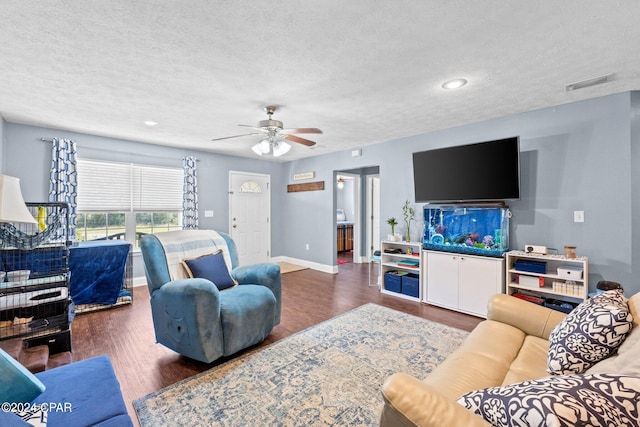 living room featuring a textured ceiling, dark hardwood / wood-style floors, and ceiling fan