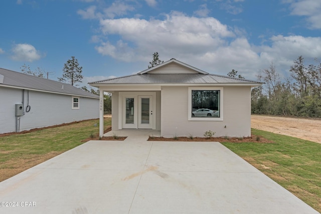 back of property featuring a yard and a patio area