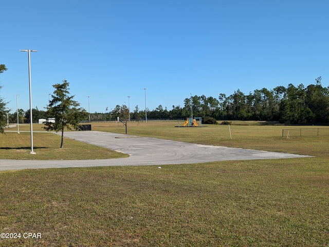 view of community featuring a playground and a yard