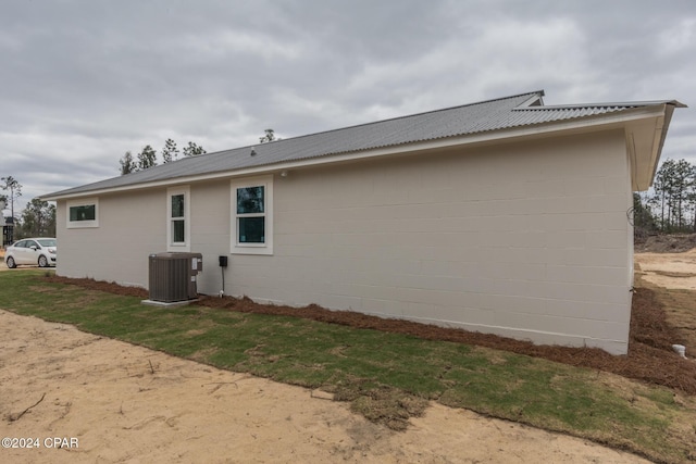 back of property featuring central AC