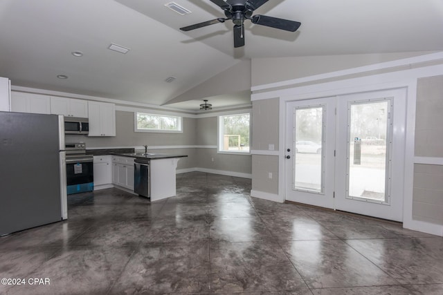 kitchen featuring kitchen peninsula, white cabinets, lofted ceiling, and appliances with stainless steel finishes