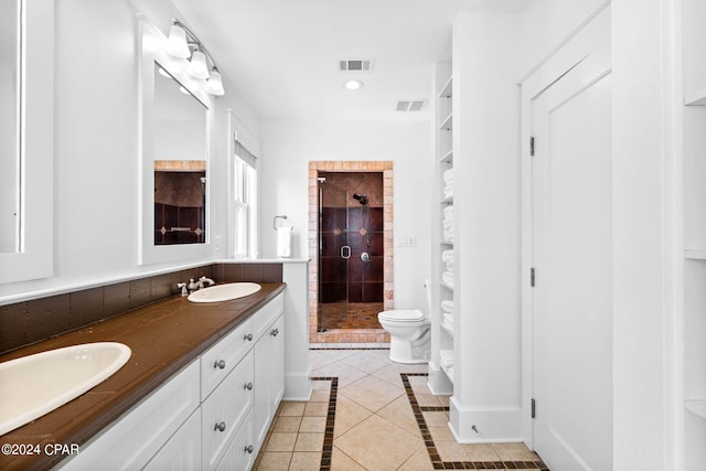 bathroom with vanity, tile patterned flooring, toilet, and a shower with shower door