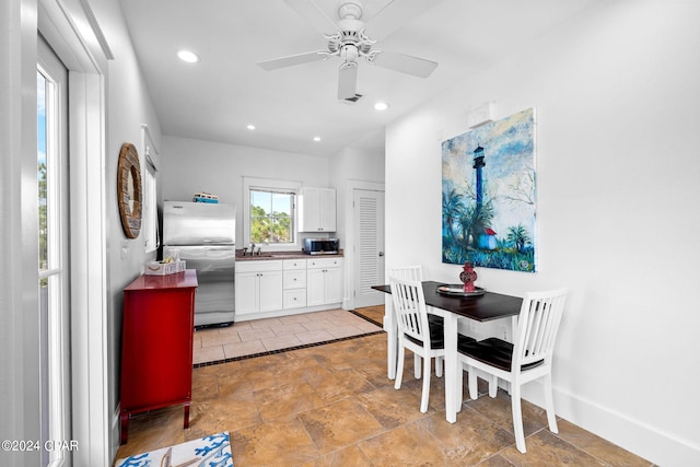 kitchen featuring stainless steel appliances, white cabinets, and ceiling fan