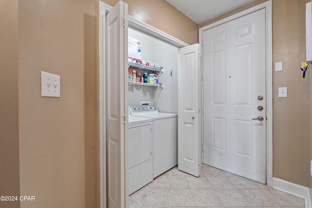 laundry area with light tile patterned floors and separate washer and dryer