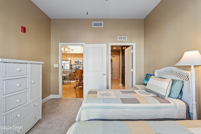 carpeted bedroom with stainless steel fridge