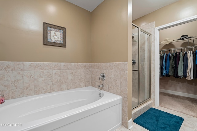 bathroom featuring independent shower and bath