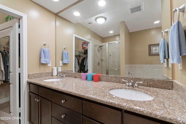 bathroom featuring vanity and a shower with shower door