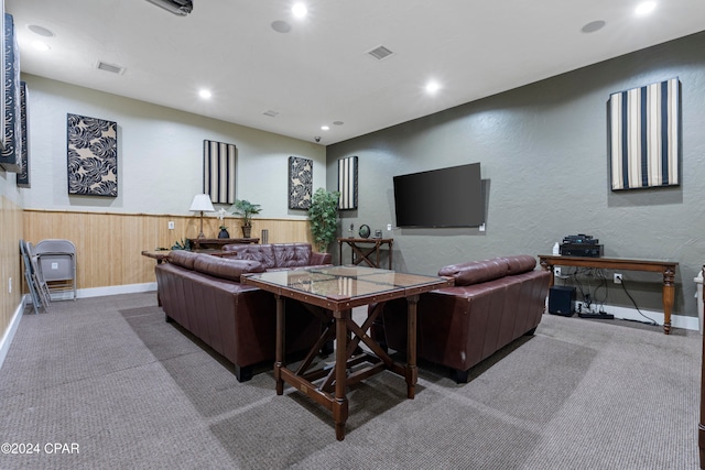 living room with wood walls and carpet floors