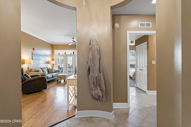 corridor with crown molding and light hardwood / wood-style flooring