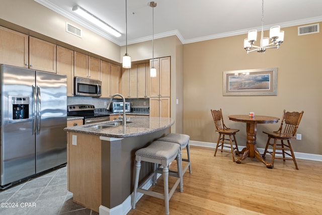 kitchen with light hardwood / wood-style flooring, dark stone countertops, crown molding, decorative backsplash, and appliances with stainless steel finishes