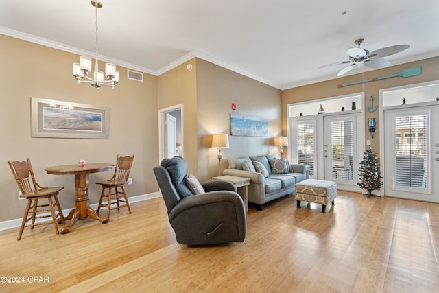 living room with ceiling fan with notable chandelier, light hardwood / wood-style floors, and crown molding