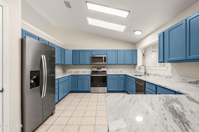 kitchen with stainless steel appliances, lofted ceiling, light stone counters, and sink