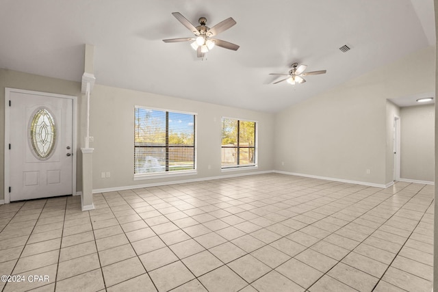 entryway with ceiling fan, light tile patterned floors, and vaulted ceiling