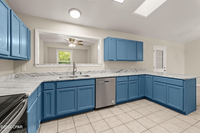 kitchen featuring light tile patterned floors, sink, stainless steel appliances, and kitchen peninsula