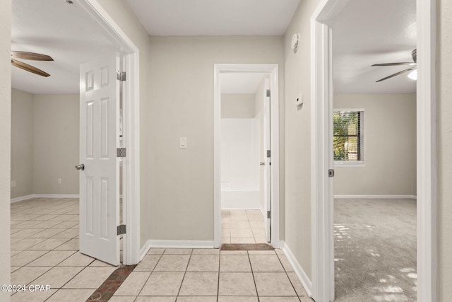 hall with light colored carpet