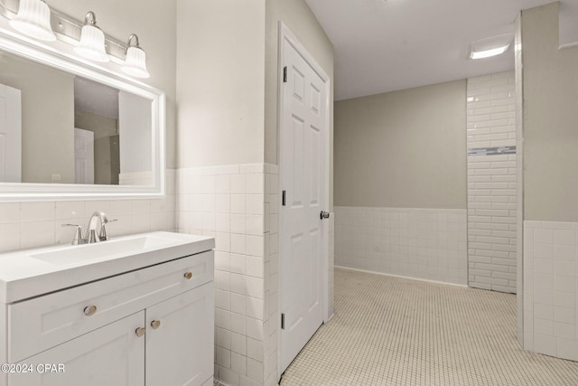 bathroom with vanity, tile walls, and tile patterned flooring