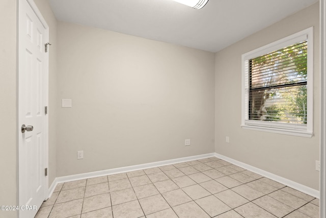 unfurnished room featuring light tile patterned floors