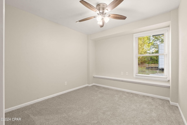 unfurnished room with ceiling fan and carpet flooring