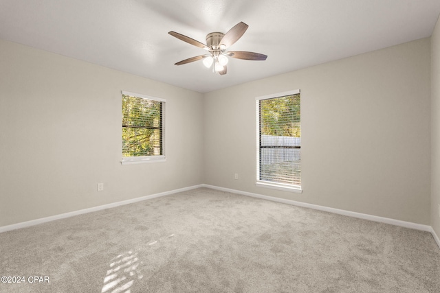 carpeted empty room featuring ceiling fan